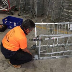 Staff-member-repairing-dairy-milk-cages-wheels